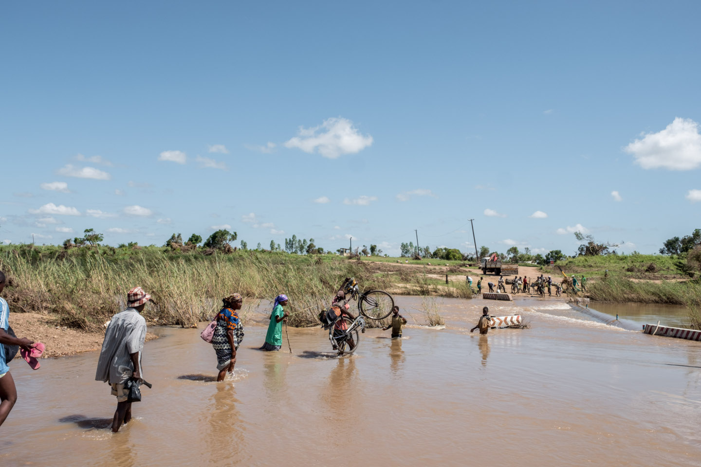 People wade across a river in flood near Nhamatanda, Mozambique ...